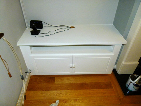 Beautiful bespoke alcove media unit with integrated storage and clean modern lines